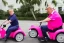 Placeholder: Photo of a donald trump riding a tricycle while wearing a pink polo shirt with the collar up