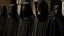 Placeholder: hooded monks in black robes in egypt