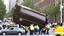 Placeholder: UPS truck crashed and flipped over on busy city street