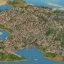 Placeholder: A small medieval coastal town next to a large river