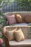 Placeholder: Night, twilight, a light brown wicker sofa with floral cushions, a glass-topped table in front of it, coffee steaming in a porcelain cup, and a down-turned open book next to it. Above the settee, flower bushes in planters, all on the terrace of a luxury house S<AI Nikon D850 highly detailed digital painting sharp focus elegant intricate photorealistic 4k very attractive beautiful dynamic lighting award winning fantastic view crisp quality Unreal Engine very cute cinematic postprocessing acrylic