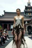 Placeholder: Female model covered in scars wears an elegant dress made of broken fishnets and sea debris exclusively designed by expensive Taiwanese designers at a fashion show with a Taiwanese temple in the background, photo