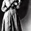 Placeholder: sepia photo illustrative Belle Starr holding a rifle and a gun, female outlaw gunslinger, 1800s dress and hat, holster and gunbelt around her waist, vignette, 8k, high-quality, ultra-fine detail, Alfredo Rodriguez, Jack Sorenson, Romain Veillon, Rafael Augusto, Annie Stokes, Greg Rutowski