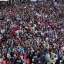 Placeholder: one future citizen speaking to massive crowd