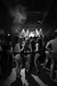 Placeholder: dans golv på en techno club, många personer som dansar, yppiga lättklädda kvinnor, scen rök och ljus strobes, svartvit bild