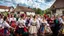 Placeholder: hungarian village wedding, group of women dancing in authentic Hungarian sárköz colorful folk dress with flowers shapes , high realistic, high qulity, detailed, happy, stunning, perfect photo