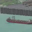 Placeholder: industrial ship offloading cargo in a harbour