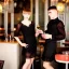 Placeholder: Russian guy boyish boylike short man's haircut boyish features in black girlish lacy cocktail dress in restaurant