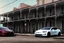 Placeholder: A Tesla 'Model Y' is parked, on the streets of New Orleans. (CINEMATIC, WIDE ANGLE LENS, PHOTO REAL)