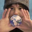 Placeholder: a Childs hand, holding the world, 8k, photorealistic