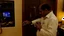 Placeholder: indian hotel keeper massages his belly button while drunk on the phone