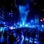 Placeholder: dark city at night, lots of people, blurred,