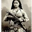 Placeholder: sepia artwork of beautiful female mexican outlaw wearing holster with two guns on waist and two rows of bullets in bandolier across chest, long black wavy hair, gorgeous, stunning face, 8k, high-quality, ultra-fine detail, 1800s wild west, detailed matte painting, brian froud, howard lyon, selina french, anna dittmann, annie stokes, lisa parker, greg rutowski, alphonse mucha