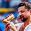 Placeholder: Volodymyr Zelensky WITH A BEARD wearing TANKTOP EATING A HOTDOG