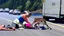 Placeholder: lady giving CPR to injured deer on highway I90 in front of a LARGE BUDGET MOVING Truck