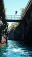 Placeholder: A diver man jumping from a top of a bridge to the bottom water