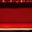 Placeholder: vivid photograph of a huge stage, where a bright spotilght illuminates a single tiny empty chair