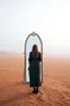 Placeholder: a woman standing in front of a mirror in the middle of the desert in foggy sky