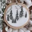 Placeholder: exquisite whimsical snowy forest in embroidery hoop, intricate, highly detailed, linen and wood backdrop