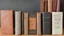 Placeholder: seven old books on a table