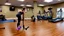 Placeholder: woman makes filthy wood floor in workout room