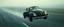 Placeholder: a high definition screen shot of a jet-fighter vw-beetle, retrofuturistic, phototrealism, in flight, one subject, rough weather