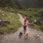 Placeholder: little boy walking on a moutain with a dog