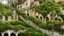 Placeholder: Gigantic mushroom village with balconies, archways, stairs, bridges, bushes, spanish moss, ivy, river, a winding pathway through the middle, in a valley