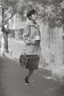 Placeholder: a student girl ,short hair with her books in her hand walking in street,next to trees.