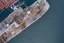 Placeholder: Aerial view of wooden ship listing, flir camera, night vision, helicopter view, drone pov, night, ship sinking