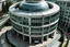 Placeholder: A semi-circular building with only 2 levels, in a 30-degree perspective in aerial view, where floor-to-ceiling windows on the second floor and glass finishes can be seen.
