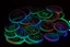 Placeholder: black background, outlines of a holographic coins, drawn from thin neon-coloured glowing lines