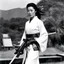 Placeholder: [photo of youthful Michelle Yeoh by helmut newton] The guardian stands tall, Kimono turned combat gear, Beauty wields power. A weapon in each hand: Skillful hands at work,Firearm and blade in balance, Enforcer's resolve. Her strength emanates, Ancient grace meets modern might, she attacks