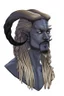 Placeholder: A tieffelin with blue skin and white Dreadlock hair. His pupil-less eyes are green. He wears a small beard. His horns are black and curved backwards. He wears a beige tunic.