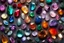 Placeholder: top view of lot of coloured gemstones in candlelight