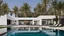 Placeholder: Description of a modern Emirati style villa: Located on a magnificent piece of land in the heart of the Emirates, our villa embodies the finesse of design and detailing that promises a luxurious residential experience. This two-story villa, with its elegant and contemporary spaces, stands out. The exterior walls of the villa are made of black and white stones, adding an elegant and luxurious touch to the design. This combination of black and white stones creates a beautiful contrast, highlight