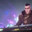 Placeholder: Generate a high resolution, photorealistic image of a character with the face of Reinhardt from Overwatch and Phraktal, DJing. The nightclub should have amazing visuals and lighting similar to a Tomorrowland or Afterlife event, and the crowd should consist of a variety of multi-cultural alien species. The image should have a level of complexity and detail similar to Gantz: 0.