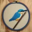 Placeholder: exquisite kingfisher in embroidery hoop, intricate, highly detailed, linen and wood backdrop