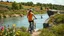 Placeholder: A lady is biking next to a river in the countryside. She moves with elegant toward camera, The background is filled with vibrant wildflowers and lush greenery along the riverbank. The camera smoothly follows her , by the way young people are swimming and a lady dives from top of a big rock to river.