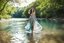 Placeholder: beautiful girl in pretty dress walking in water toward camera in trees next to wavy river with clear water and nice sands in floor.camera capture from her full body front