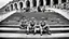 Placeholder: retro old photo of a young couple in 70s style clothes sitting on the lower steps of the Danube embankment in Budapest at Fővám Square, the photo is old, stained, scratched in some places, the girl's and the boy's faces are blurry and not clearly visible, behind them are stairs