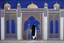 Placeholder: an open gothic_Arab gate in a blue-tiled wall with a view of an old city by artist "Beardsley",by artist "Rachman",by artist "Kay Nielson",by artist "Bertha Lum",by artist "Dulac",by artist "Erte"