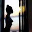 Placeholder: A silhouette of a sensual tender girl longing for a kiss, looking at the sunset from the window that creates her shadow.