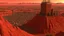 Placeholder: Desert warrior from behind looking at a city on a plato in the distance,