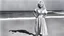 Placeholder: youthful Dolly Parton singing her famous "God/Deicide" country tube on the beach