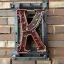 Placeholder: The letter P from the alphabet, constructed from machine parts, steampunk-style as a door sign