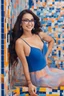 Placeholder: full body, head to toe - multicolored, neon lit, tiled floor - cat-eye framed eyeglasses - sky blue and navy blue gradated background -- multicolored, neon lit, tiled floor -- it's the 1950s - smiling 18-year-old Brianne Devereaux, big boobs, long, black hair, ponytail, blue eyes, short pleated plaid wool skirt, cotton blouse, a wool sweater, oxford shoes, and a neck scarf, professional quality studio 8x10 UHD Digital photograph, multicolored spotlight, Photorealistic, realistic stock photo,