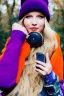 Placeholder: blonde taking selfie.thick thighs,thick calves,flat belly,curvy fell. big head. Mantle is sewed of upcycled Denim and sewed together of camouflage pieces. Pieces' color are orange, cream and purple. It is with big bright purple felt tippet and birght-colored-hood is merged with colorful beanie. Big colored headphones (gold rings!) is merged with small felt cap with small visor. Style: Haute Couture in 1950's Brazil, N.Y.C fashion in 2023