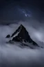 Placeholder: one single mountain sharp face rises out of the mist into the night sky.