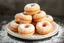 Placeholder: fresh old-fashioned mini doughnuts completely covered in powdered sugar